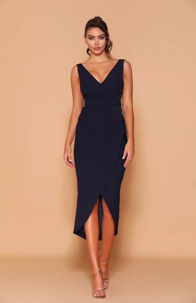 A gorgeous fully lined mid-length dress with a V-neckline which crosses over with gathered detailing on the bodice, and continues onto the waistline.